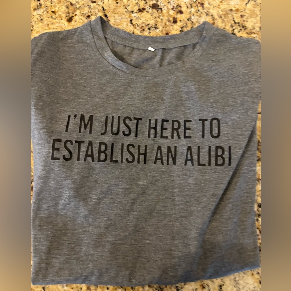 Graphic Tee - “I’m just here for the alibi” NWOT